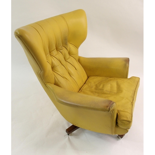 900 - A 1960's yellow leather button back swivel rocker