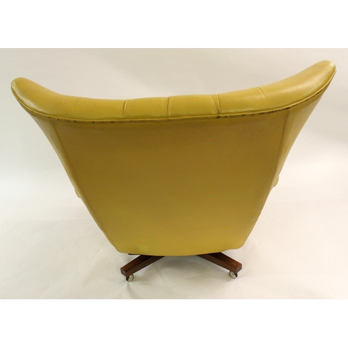 900 - A 1960's yellow leather button back swivel rocker