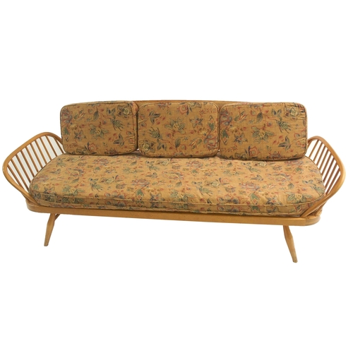 909 - A light Ercol daybed with floral cushions