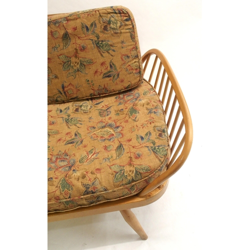 909 - A light Ercol daybed with floral cushions