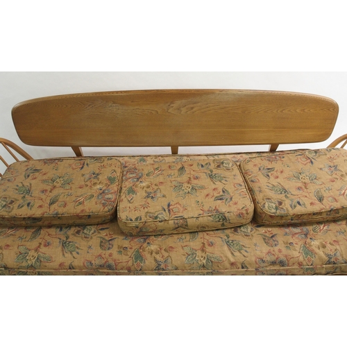 909 - A light Ercol daybed with floral cushions