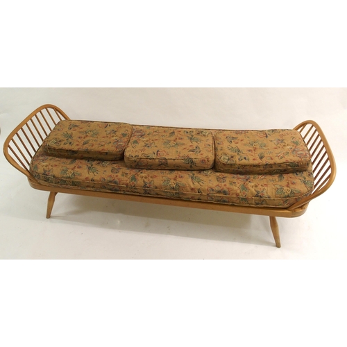 909 - A light Ercol daybed with floral cushions