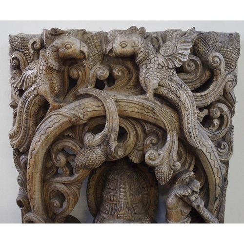 139 - A large Burmese carved hardwood panel