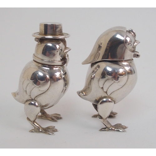 167 - A pair of novelty white-metal pepperettes formed as chicks