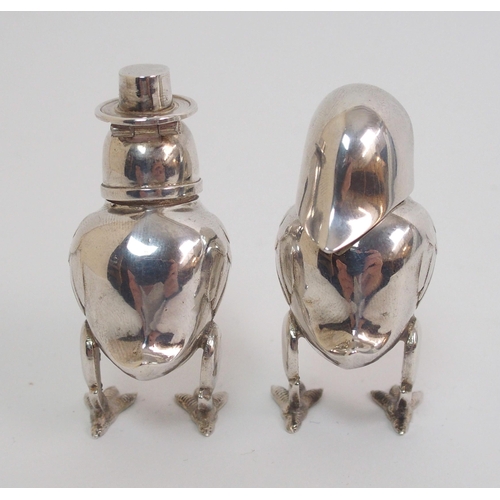 167 - A pair of novelty white-metal pepperettes formed as chicks