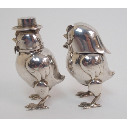 167 - A pair of novelty white-metal pepperettes formed as chicks