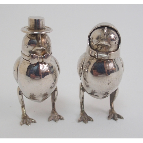 167 - A pair of novelty white-metal pepperettes formed as chicks