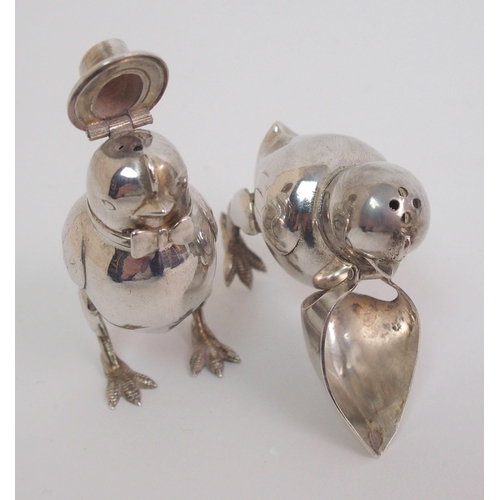 167 - A pair of novelty white-metal pepperettes formed as chicks