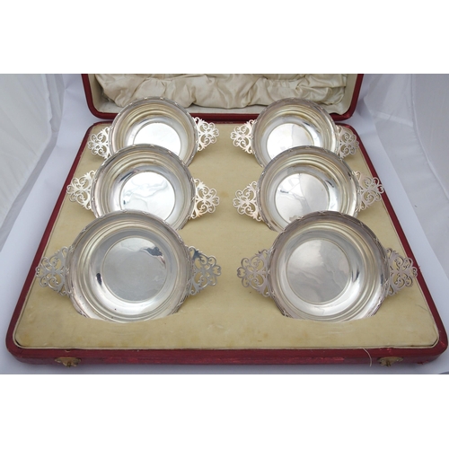 184 - A cased set of six silver porringers with pierced handles