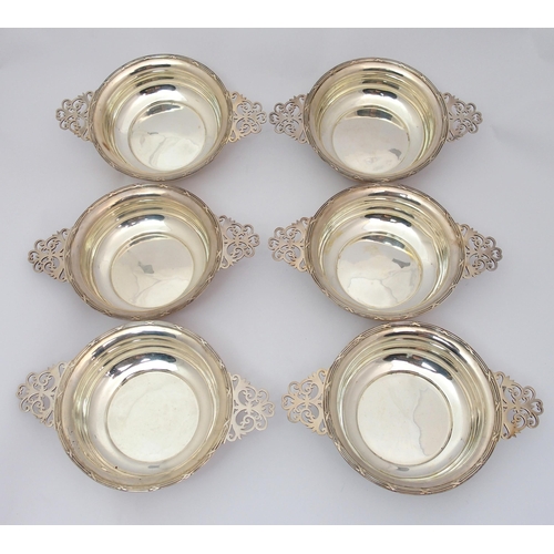 184 - A cased set of six silver porringers with pierced handles