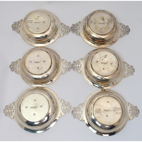 184 - A cased set of six silver porringers with pierced handles