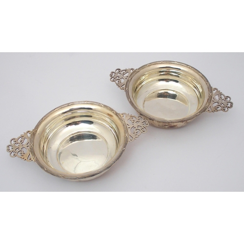 184 - A cased set of six silver porringers with pierced handles