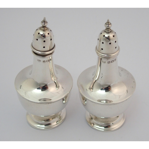 203 - A cased pair of silver pepperettes