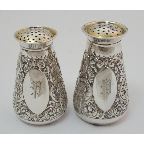 203 - A cased pair of silver pepperettes