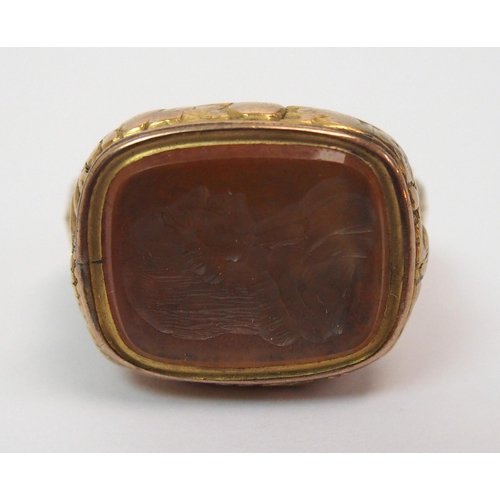 269 - An early 18th century gilt-metal fob seal depicting the bust of John Wesley