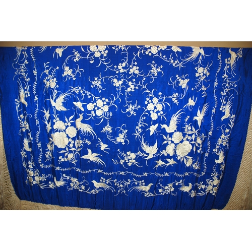 275 - A white silk embroidered piano shawl