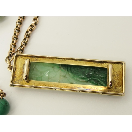 706 - A 14ct gold Chinese green hardstone pendant