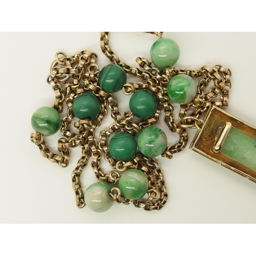 706 - A 14ct gold Chinese green hardstone pendant