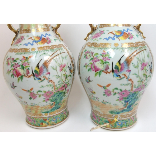 71 - A pair of Canton famille rose two handled vases