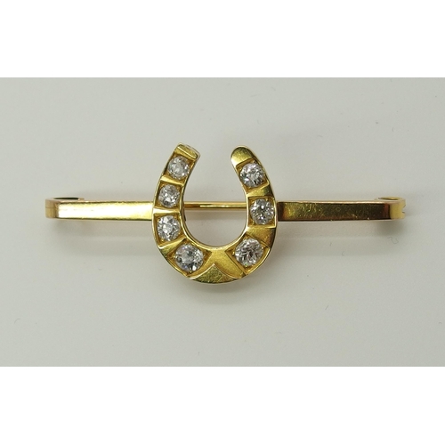 712 - A 9ct gold diamond set horseshoe brooch