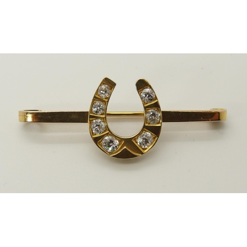 712 - A 9ct gold diamond set horseshoe brooch