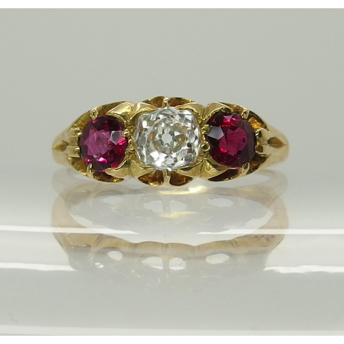 722 - A bright yellow metal ruby and diamond ring