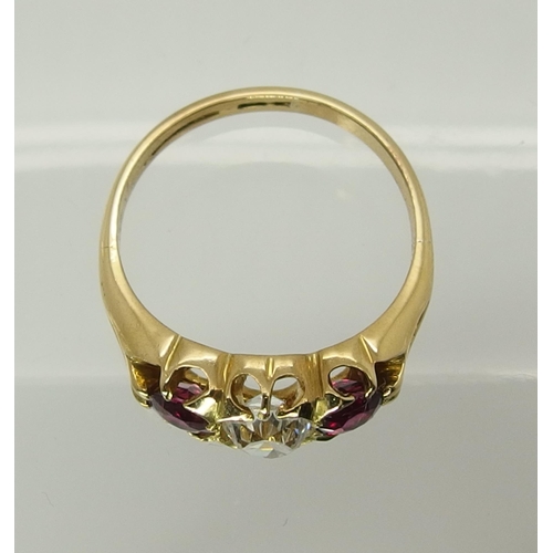 722 - A bright yellow metal ruby and diamond ring