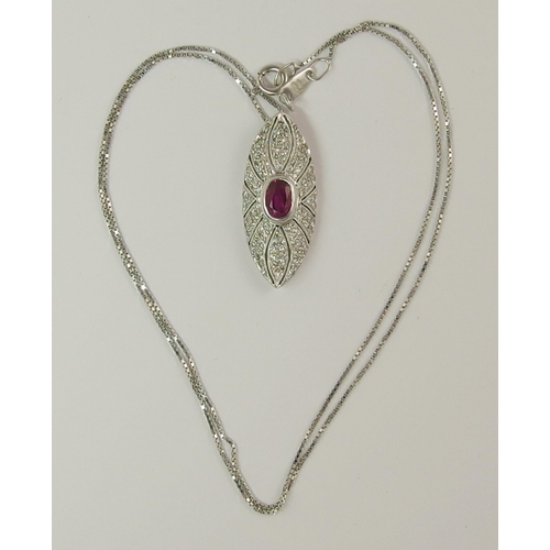 732 - An 18ct white gold ruby and diamond pendant