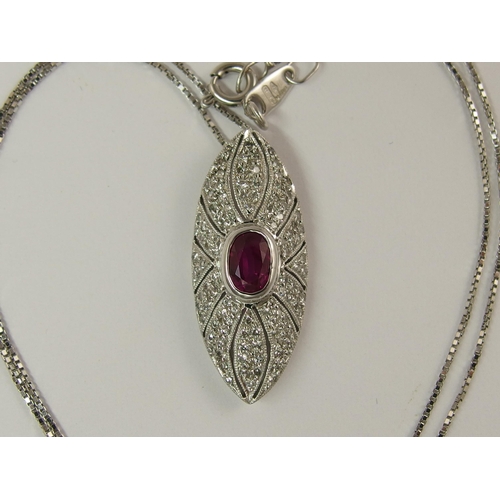 732 - An 18ct white gold ruby and diamond pendant