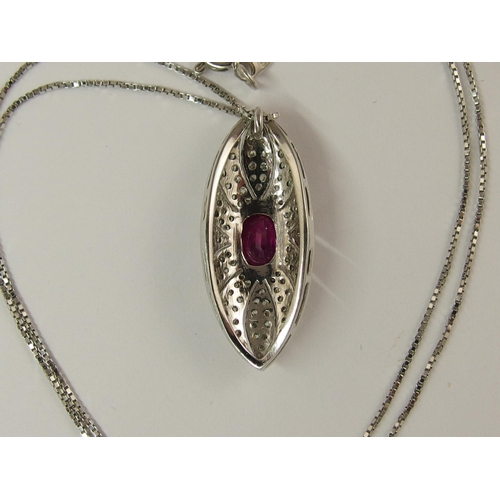 732 - An 18ct white gold ruby and diamond pendant