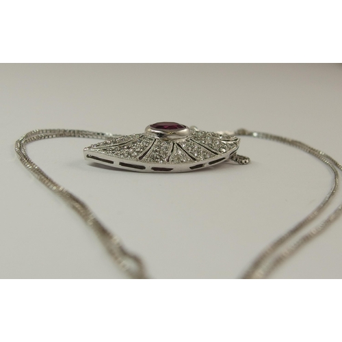 732 - An 18ct white gold ruby and diamond pendant