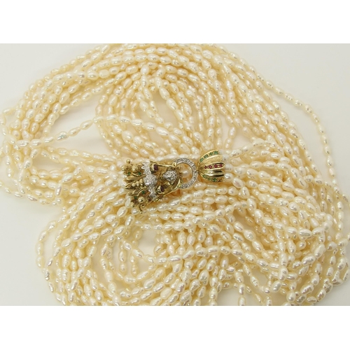 735 - A multi string freshwater pearl necklace with a 14ct gold Dragon clasp