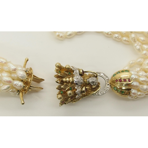 735 - A multi string freshwater pearl necklace with a 14ct gold Dragon clasp