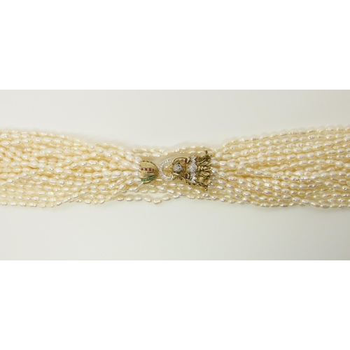 735 - A multi string freshwater pearl necklace with a 14ct gold Dragon clasp