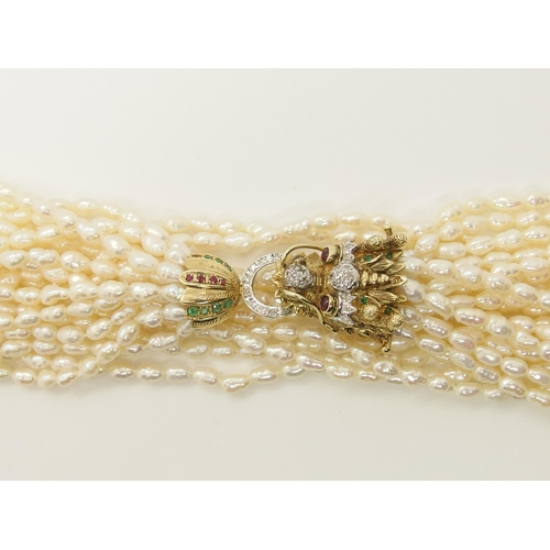 735 - A multi string freshwater pearl necklace with a 14ct gold Dragon clasp