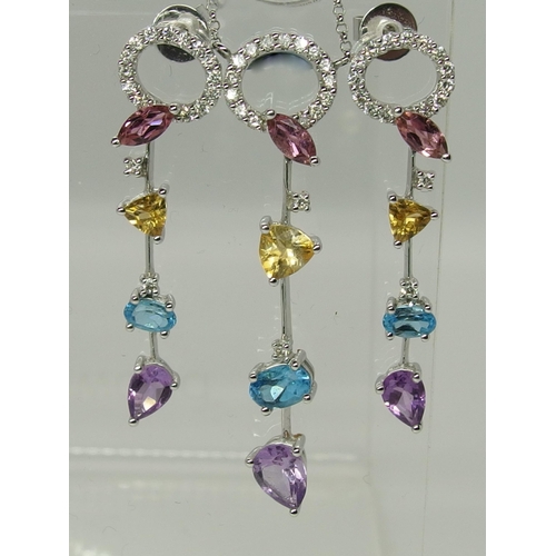 747 - An 18ct white gold diamond and mixed gem stone pendant with matching earrings