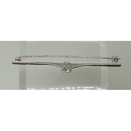 749 - An 18ct gold bar brooch set with a diamond