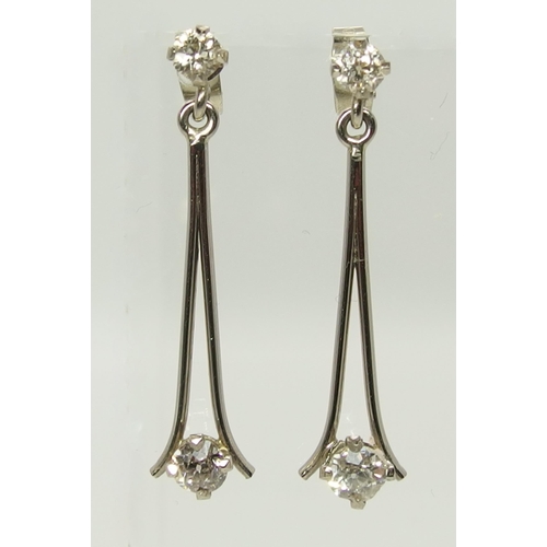 751 - A pair of white metal diamond drop earrings