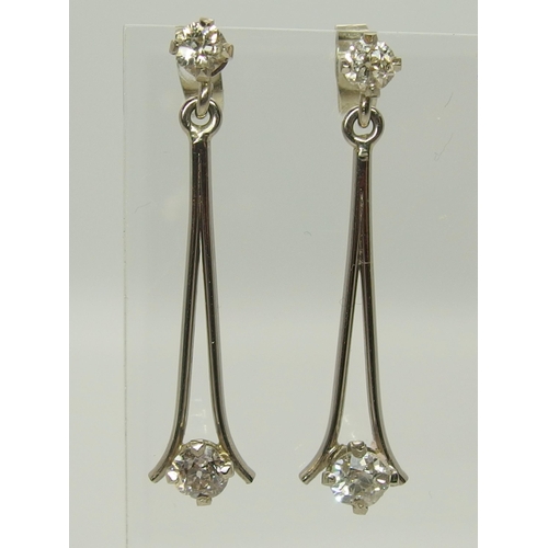 751 - A pair of white metal diamond drop earrings