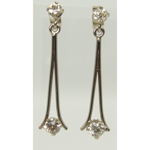 751 - A pair of white metal diamond drop earrings