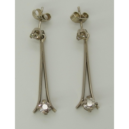 751 - A pair of white metal diamond drop earrings