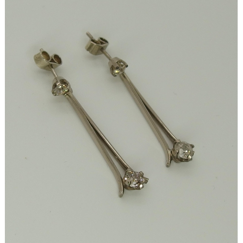 751 - A pair of white metal diamond drop earrings