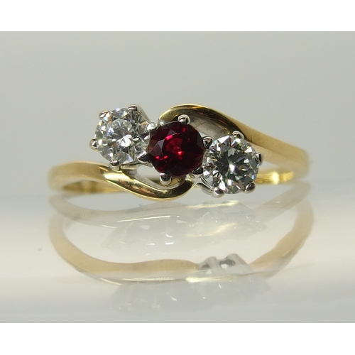 754 - An 18ct gold diamond and red gem three stone ring