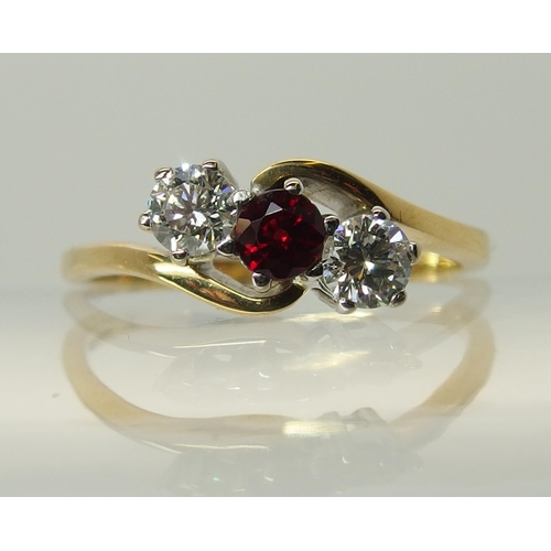 754 - An 18ct gold diamond and red gem three stone ring