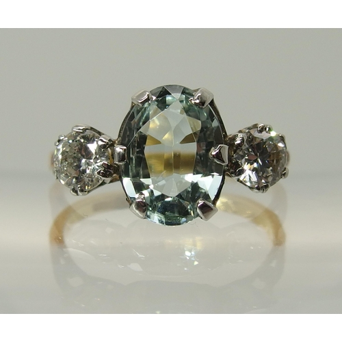 756 - An 18ct gold aquamarine and diamond three stone ring