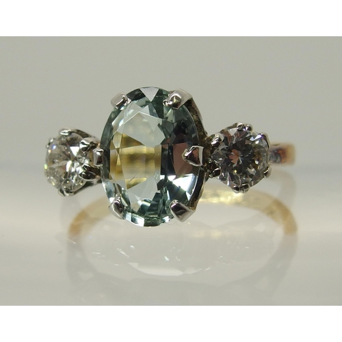 756 - An 18ct gold aquamarine and diamond three stone ring