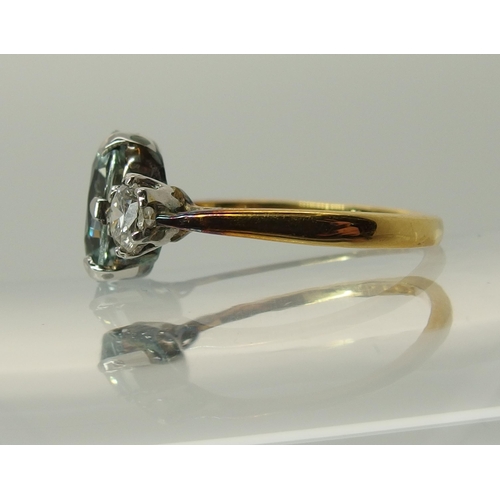 756 - An 18ct gold aquamarine and diamond three stone ring