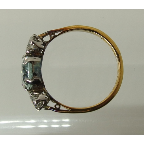 756 - An 18ct gold aquamarine and diamond three stone ring