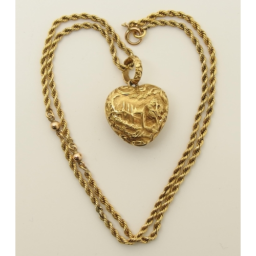 764 - A bright yellow metal heart shaped locket