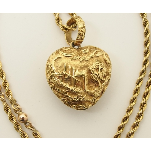 764 - A bright yellow metal heart shaped locket